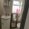 Photo 4: The bathroom features a new sink, mirror, lockers, and a new toilet.