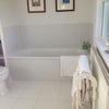 Photo 5: Calm bathroom with bath and large shower (not visible in this photo)