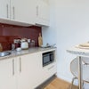Photo 3: Fully functional kitchen with plenty of storage, induction, fridge and microwave/ oven