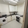 Photo 5: Shared kitchen showing cooker and washing machine