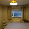 Photo 2: Room 1: Window has a french blind and curtains. The double bed has 4 drawers underneath.