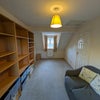 Photo 8: Room 2: shelf storage with containers and a side table. Not pictured: Double bed with 4 drawers.