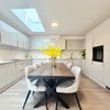 Photo 9: Bright Communal Kitchen with Table