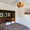 Photo 4: Bedroom 1 with lots of built in storage, double bed with a reclaimed door as headboard.