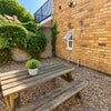 Photo 9: Lovely outdoor garden space with table and seatings!