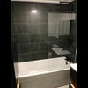 Photo 5: an extension of the bathroom featuring a full-size bathtub and a powerful overhead rainfall shower