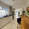 Photo 11: Communal Kitchen and Living Area