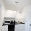 Photo 7: Fridge freezer, toaster, kettle, microwave and induction plug in hob provided.