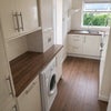 Photo 7: Modern kitchen with washing machine, gas hobs, electric oven, microwave and large fridge freezer.