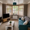 Photo 3: Big bay window offers lots of light into a spacious lounge and dining area.