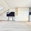 Photo 4: Built-in wardrobe and generous open-plan living area.