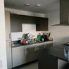 Photo 5: Open concept kitchen with tons of shelf storage both personal and shared and a convection hob
