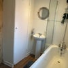 Photo 9: Bathroom with shower over bath and storage cupboard