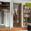 Photo 4: Room showing storage and view to staircase. Books will be removed!