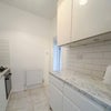 Photo 5: Newly fitted kitchen with marble-effect worktops