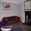 Photo 8: Comfortable shared TV lounge with 2 sofas and small dining table and chairs