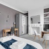 Photo 3: Bedroom with TV and chairs