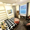 Photo 2: Room 1 large room now with beautiful teal velvet sofa! 