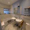 Photo 5: Shared bathroom with his and hers sinks and cabinets
