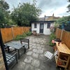Photo 6: A huge paved garden with a barbecue, outdoor table/benches, and sun loungers
