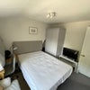 Photo 2: Further view of  bedroom with  TV