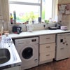 Photo 7: kitchen with two fridges, a washing machine and cooker