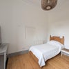 Photo 2: bedroom with large window and wooden floor