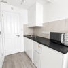 Photo 3: Fridge freezer, toaster, kettle, microwave and induction plug in hob provided.