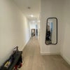 Photo 9: Hallway, entrance to flat. Closet on the right is the laundry. 