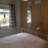 Photo 5: Double bedroom with lots of cupboard storage and windows to the garden.