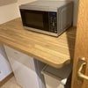Photo 8: Fridge, sink, microwave, toaster plus plates, glasses etc. 