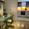 Photo 2: Dining area and kitchen 