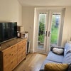 Photo 5: Common area/ living room (the sofa is now in the other area) + view of garden 