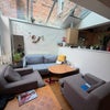 Photo 6: Common area/ living room (between kitchen and the other common area that leads to the garden)
