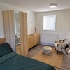 Photo 3: Bright open-plan living and sleeping space with double bed, wardrobe and ample storage.