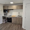 Photo 4: Private fitted kitchen with integrated oven, hob, microwave, sink and storage.