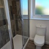 Photo 7: Modern, bright bathroom with shower, WC and radiator.