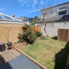Photo 6: Our lovely garden (complete with braai/ BBQ)!