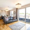 Photo 3: Bright open-plan living room with balcony access