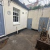 Photo 1: Front courtyard with understreet storage
