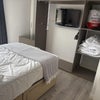 Photo 2: Tv on wall with surrounding wardrobe area 