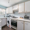 Photo 10: Full kitchen with Tassimo coffee maker, toaster, kettle, microwave, oven, washing machine, utensils