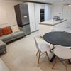 Photo 4: The lounge equipped with comfy sofa, dining table a nd wall mounted TV