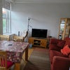 Photo 7: Shared living room with sofa and TV