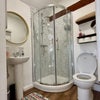 Photo 7: Modern Bathroom with Shelving, Power Shower + Towel Rail