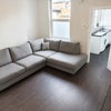 Photo 3: Spacious shared living room with large corner sofa