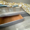 Photo 10: additional storage space under the bed