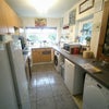 Photo 2: ... spacious kitchen with an abundance of storage.