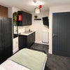 Photo 8: 🛏️ Contemporary Furnished Room with Feature Slat-Wall Finish