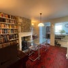 Photo 3: Middle room with dining table, working wood burning stove and upright piano